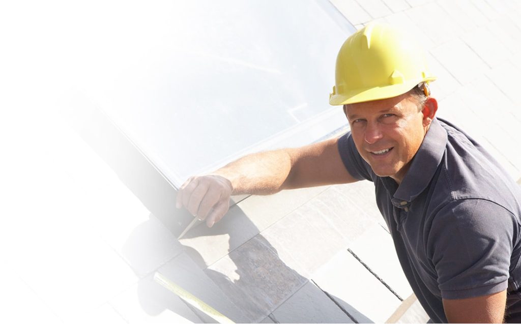 Man working on roof and smiling