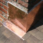 Close up of a metal casing around a chimney
